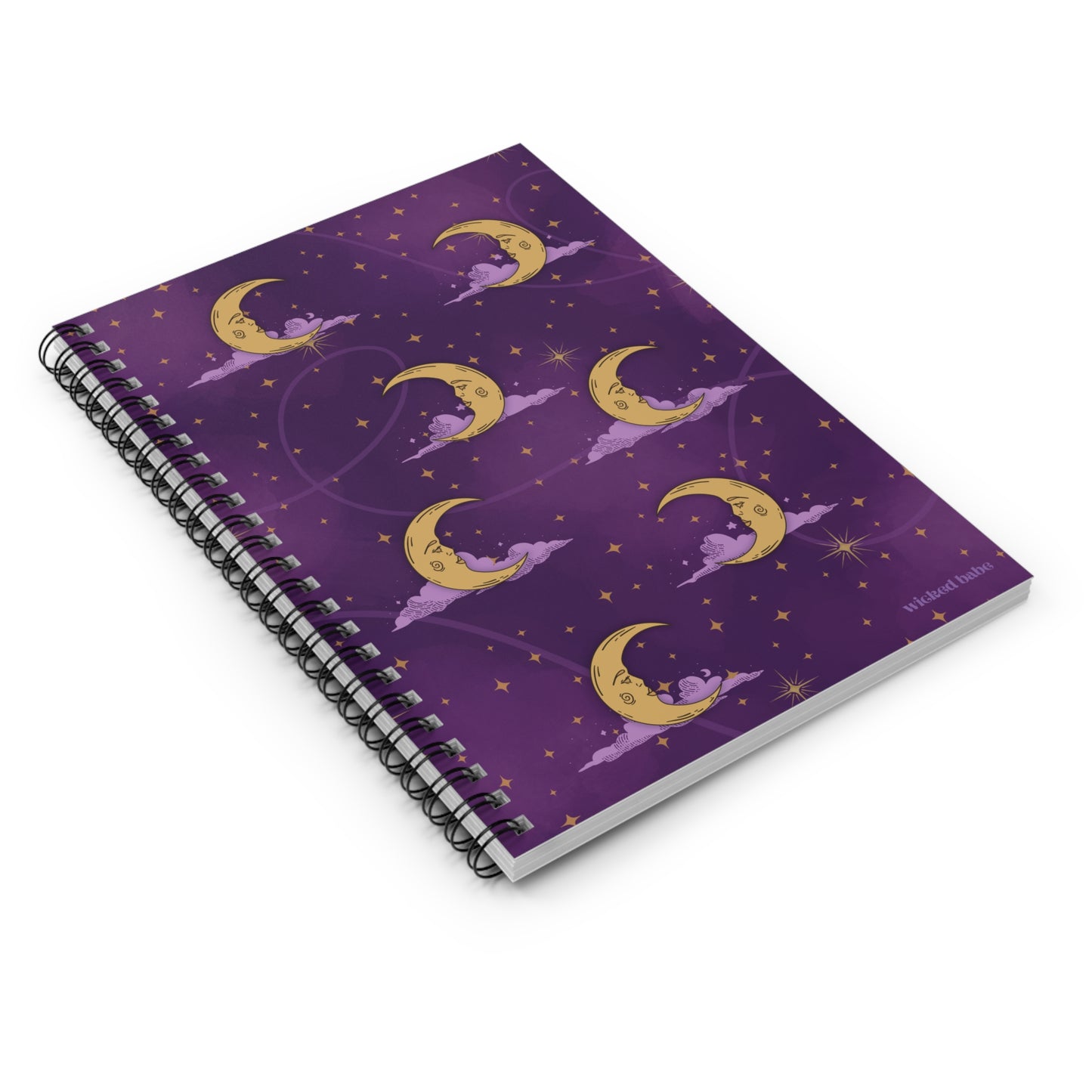 Flatlay of a spiral hardcover notebook with purple celestial sky with gold crescent moon and stars