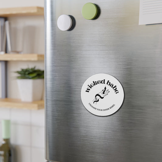 White circular refrigerator magnet with 'wicked babe' hand with serpent logo in black on a stainless steel fridge