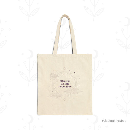 Canvas tote bag with mystical witchy rebellious text in purple surrounded by clouds and stars