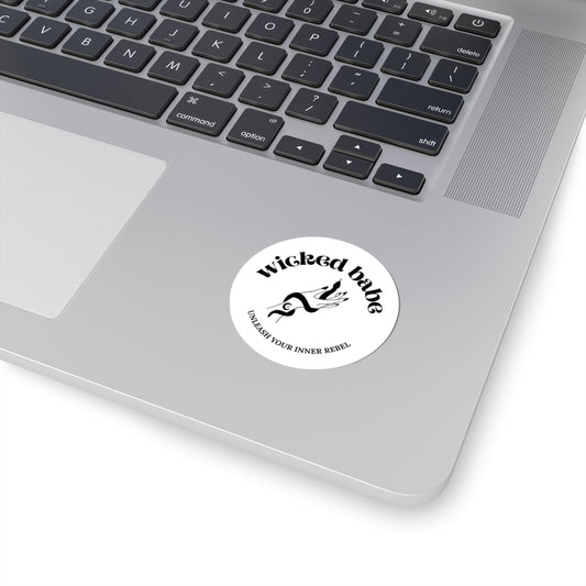 2 inch white circular sticker with 'wicked babe' hand with serpent logo in black on a laptop
