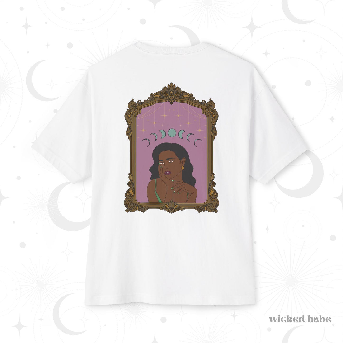 Oversized short sleeve white t-shirt with design of a dark skinned woman with black hair wearing green on a pink background with moon phases above surrounded by ornate gold frame on the back