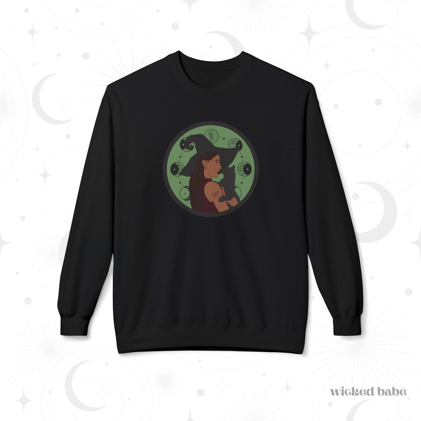 Black crewneck long sleeve pullover sweatshirt featuring a design of a woman wearing a witch's hat holding a gray cat with moon phases on a green background