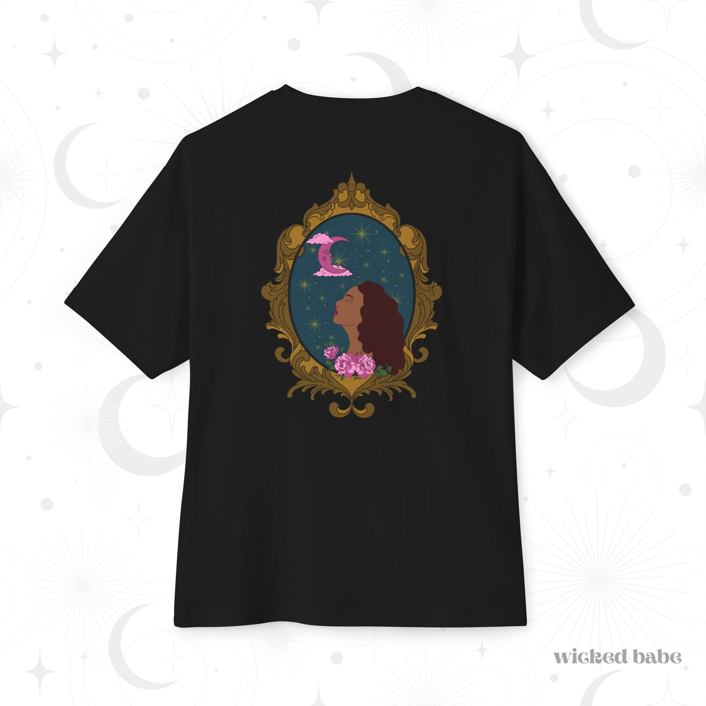 Oversized short sleeve black t-shirt with a design of a tan skinned woman with red brown wavy hair with pink flowers and a pink crescent moon above on a teal background surrounded by an ornate gold frame on the back