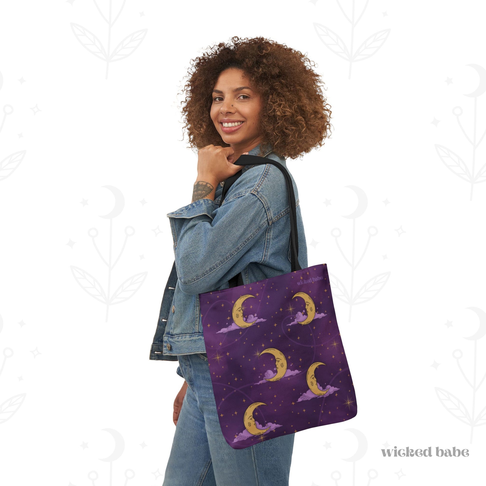 Woman carrying a 16x16 inch tote bag with purple celestial sky with gold crescent moon and stars