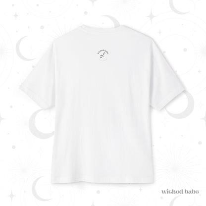 The back of an oversized short sleeve white t-shirt with small black wicked babe hand with serpent logo in the upper center