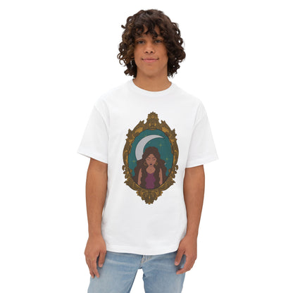 Man wearing an oversized short sleeve white t-shirt with a design of a tan skinned woman with brown wavy hair wearing purple in front of large crescent moon on a teal background surrounded by ornate gold frame