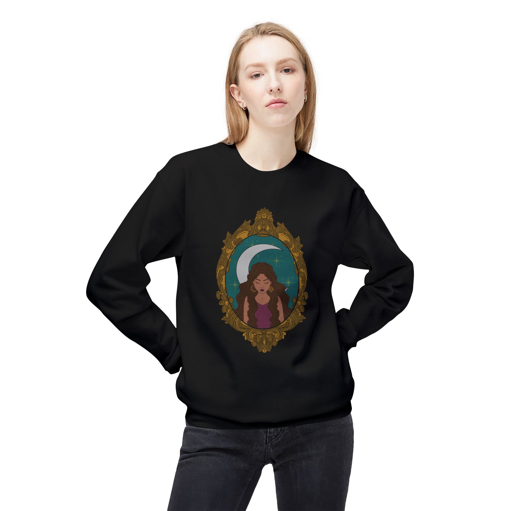 Woman wearing a black long sleeve crewneck sweatshirt with design of a tan skinned woman with brown wavy hair wearing purple in front of large crescent moon on a teal background surrounded by ornate gold frame