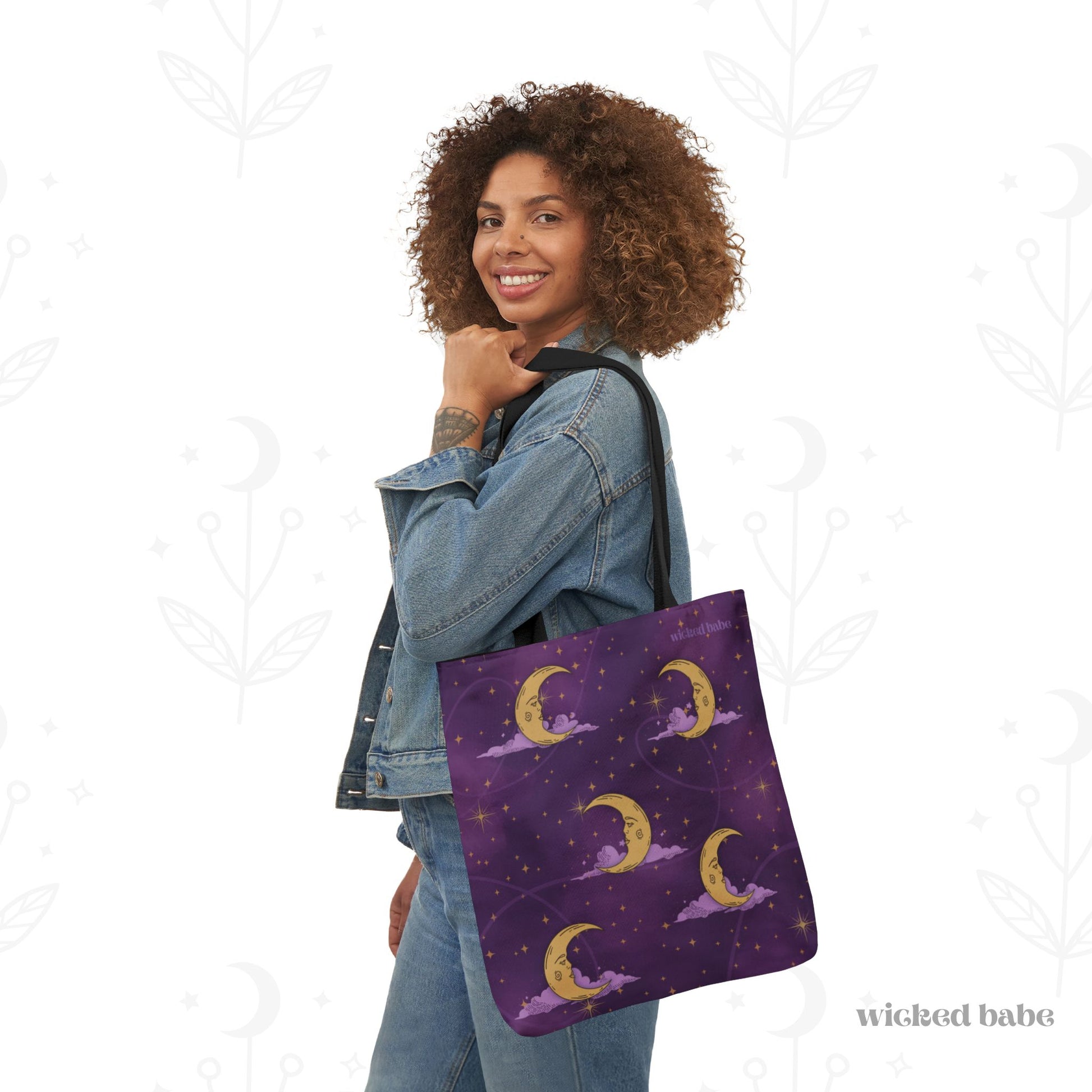 Woman carrying a 18x18 inch tote bag with purple celestial sky with gold crescent moon and stars