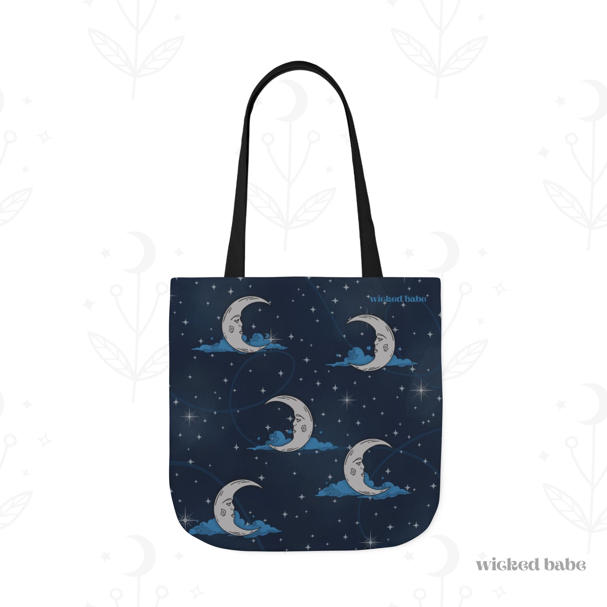 The back of a 18x18 inch tote bag with blue celestial sky background with silver crescent moon and stars