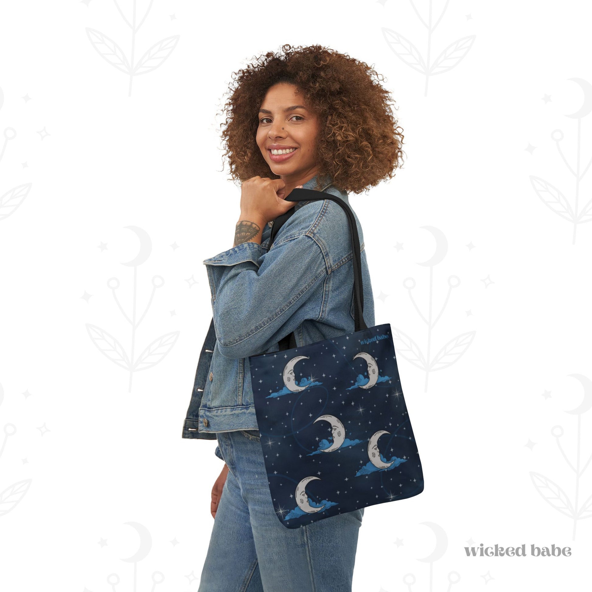 Woman carrying 13x13 inch tote bag with blue celestial sky background with silver crescent moon and stars