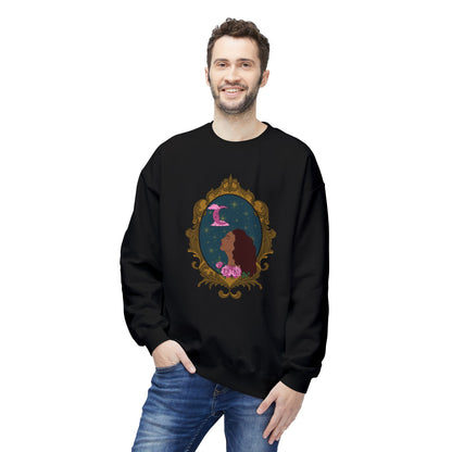 Man wearing a black long sleeve crewneck sweatshirt with design of a tan skinned woman with red brown wavy hair with pink flowers and a pink crescent moon above on a teal background surrounded by an ornate gold frame