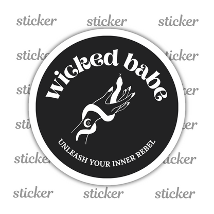 Charcoal circular sticker with 'wicked babe' hand with serpent logo in white with a white border