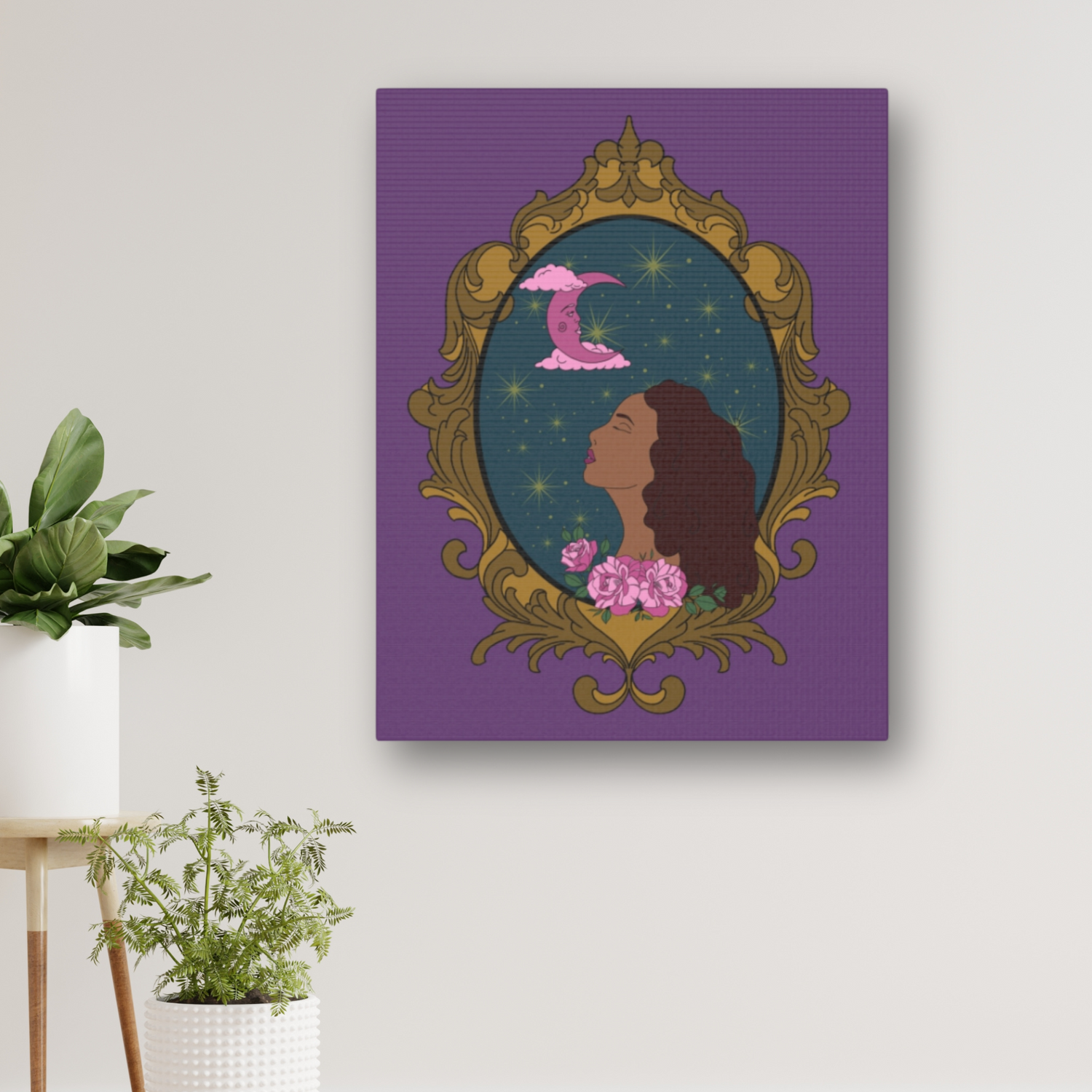 Matte purple canvas wall art with design of a tan skinned woman with red brown wavy hair with pink flowers and a pink crescent moon above on a teal background surrounded by an ornate gold frame hung on a wall near plants