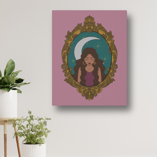 Matte pink canvas wall art with design of a tan skinned woman with brown wavy hair wearing purple in front of large crescent moon on a teal background surrounded by ornate gold frame hung on a wall near plants