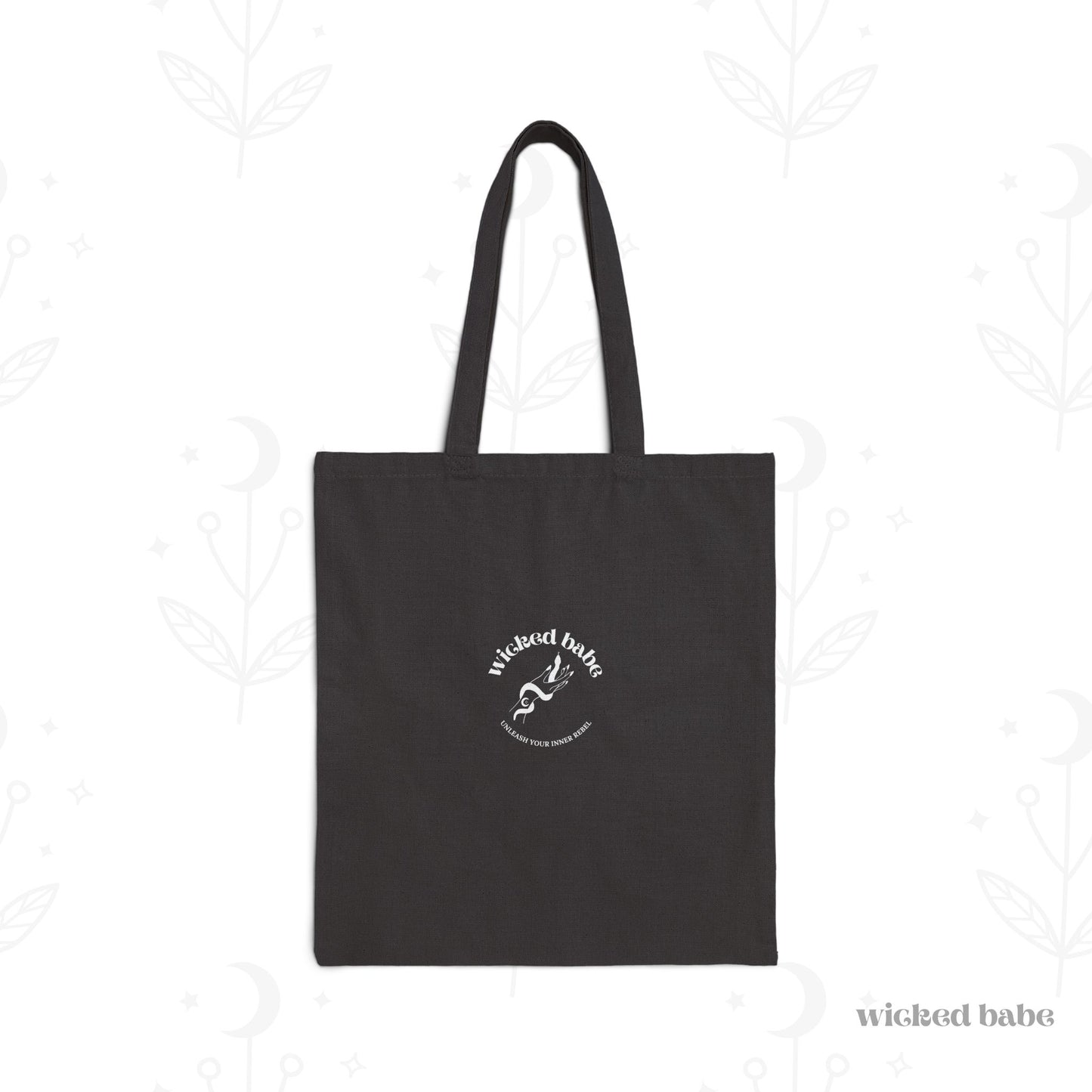 The back of a black tote bag with white wicked babe hand with serpent logo in the center