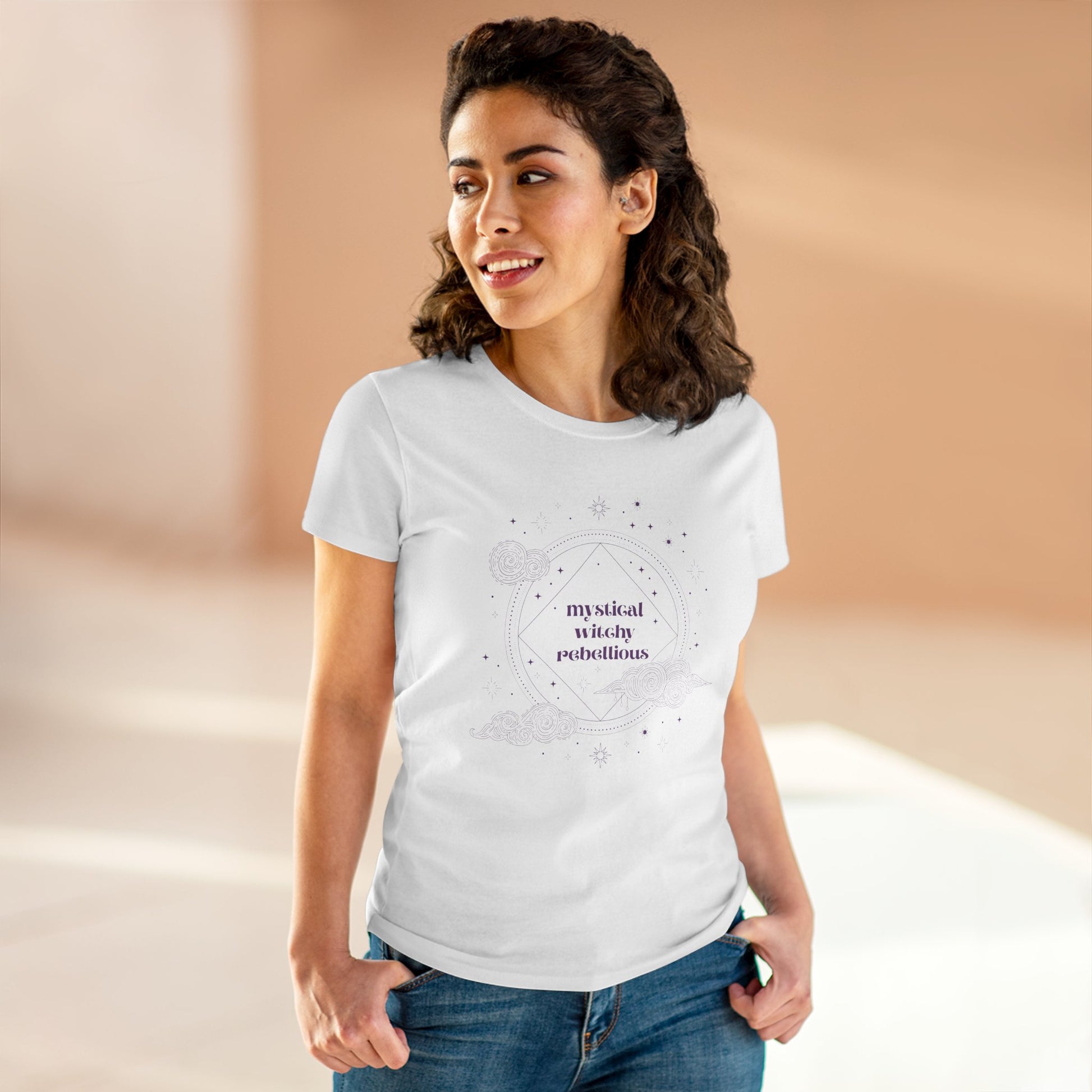 Woman wearing white short sleeve crewneck t-shirt with mystical witchy rebellious text in purple surrounded by clouds and stars