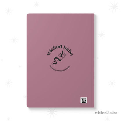 Back of pink softcover journal notebook with black wicked babe hand with serpent logo in the center