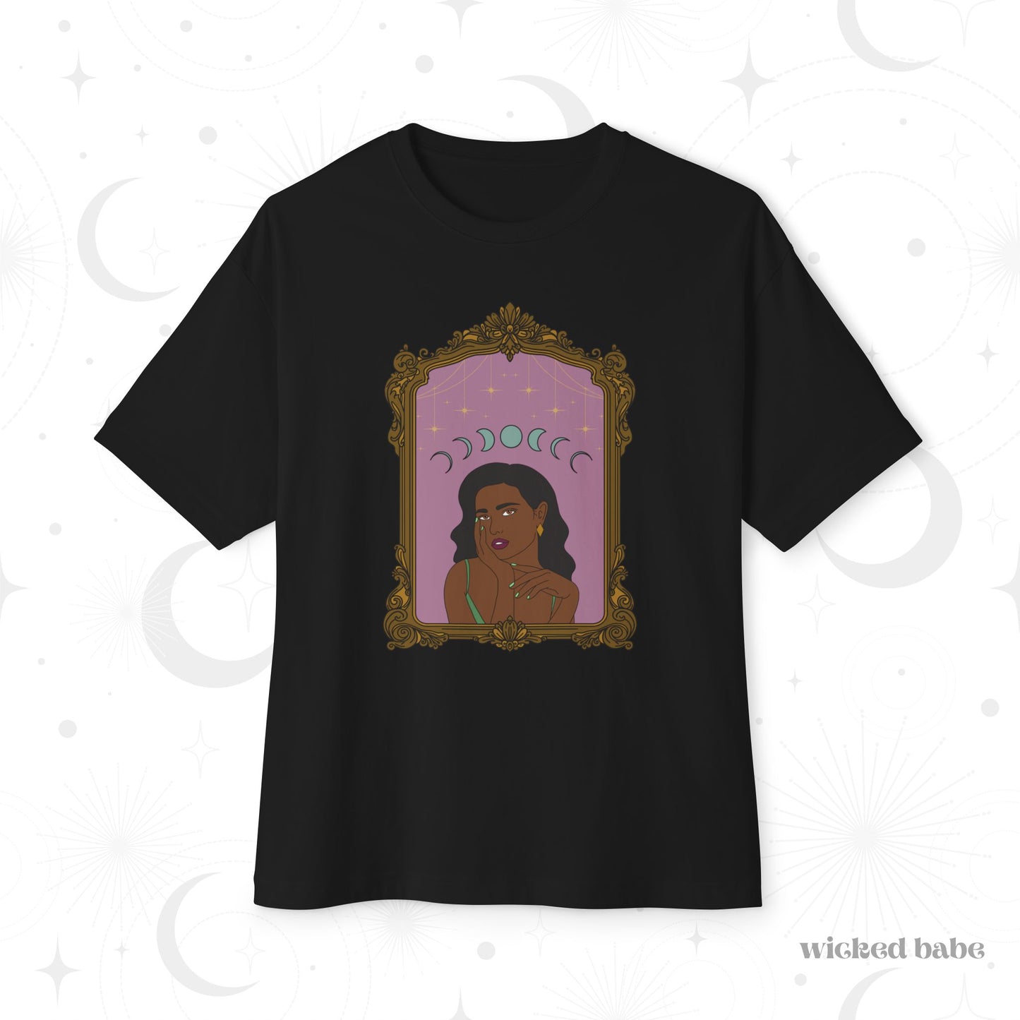 Oversized short sleeve black t-shirt with design of a dark skinned woman with black hair wearing green on a pink background with moon phases above surrounded by ornate gold frame