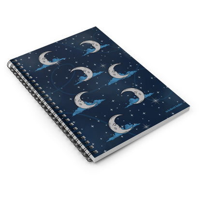Flatlay of spiral hardcover notebook with blue celestial sky with silver crescent moon and stars