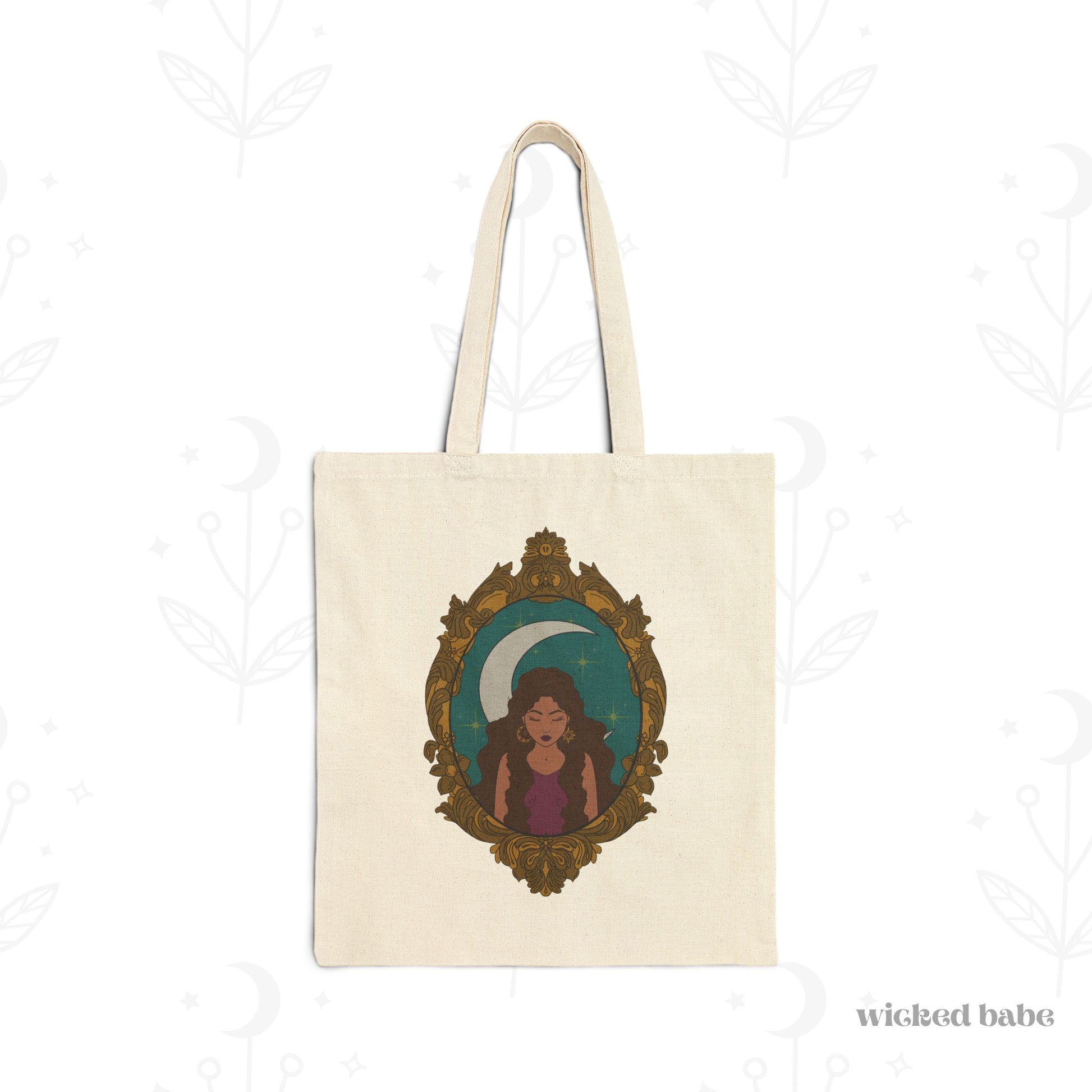 Canvas tote bag with design of a tan skinned woman with brown wavy hair wearing purple in front of large crescent moon on a teal background surrounded by ornate gold frame