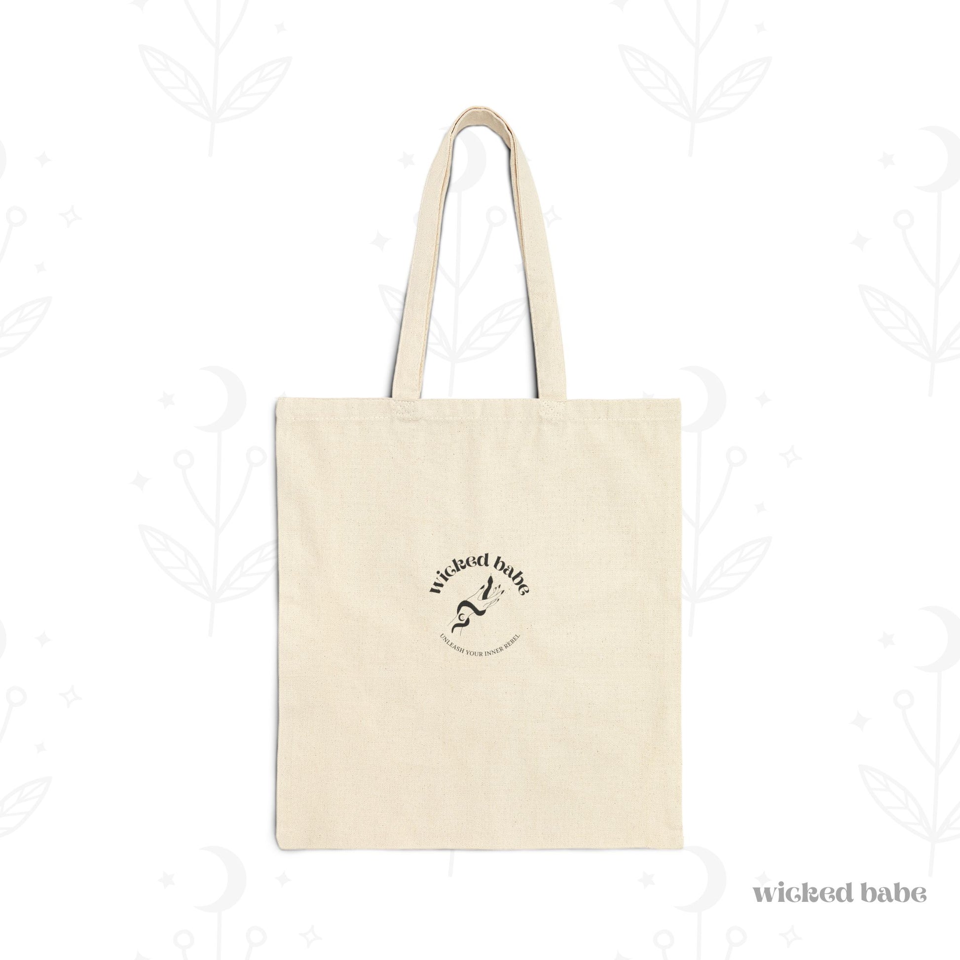 The back of a canvas tote bag with black wicked babe hand with serpent logo in the center