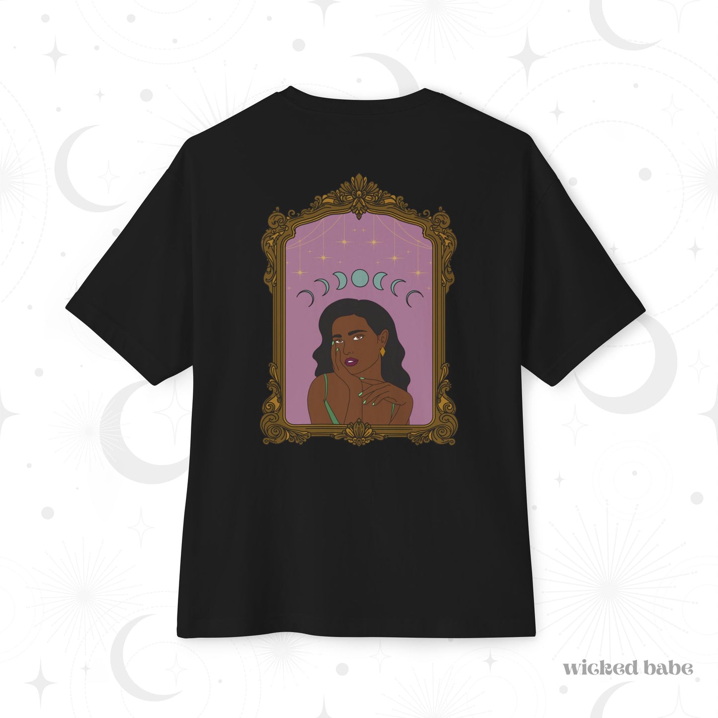 Oversized short sleeve black t-shirt with design of a dark skinned woman with black hair wearing green on a pink background with moon phases above surrounded by ornate gold frame on the back