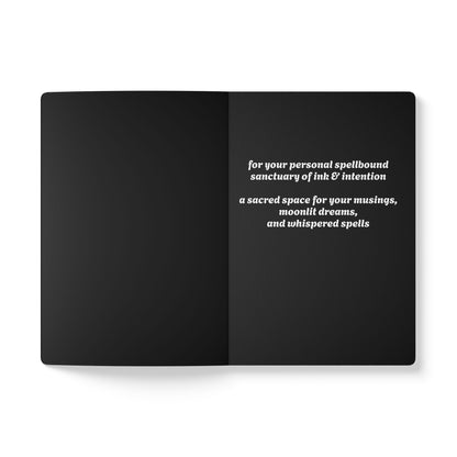 Inside second page of black journal notebook with inspirational text in white