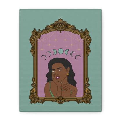 Front view of matte green canvas wall art with design of a dark skinned woman with black hair wearing green on a pink background with moon phases above surrounded by ornate gold frame