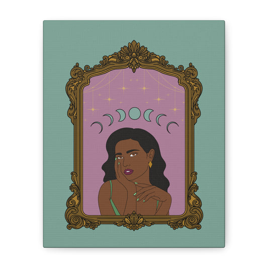 Front view of matte green canvas wall art with design of a dark skinned woman with black hair wearing green on a pink background with moon phases above surrounded by ornate gold frame