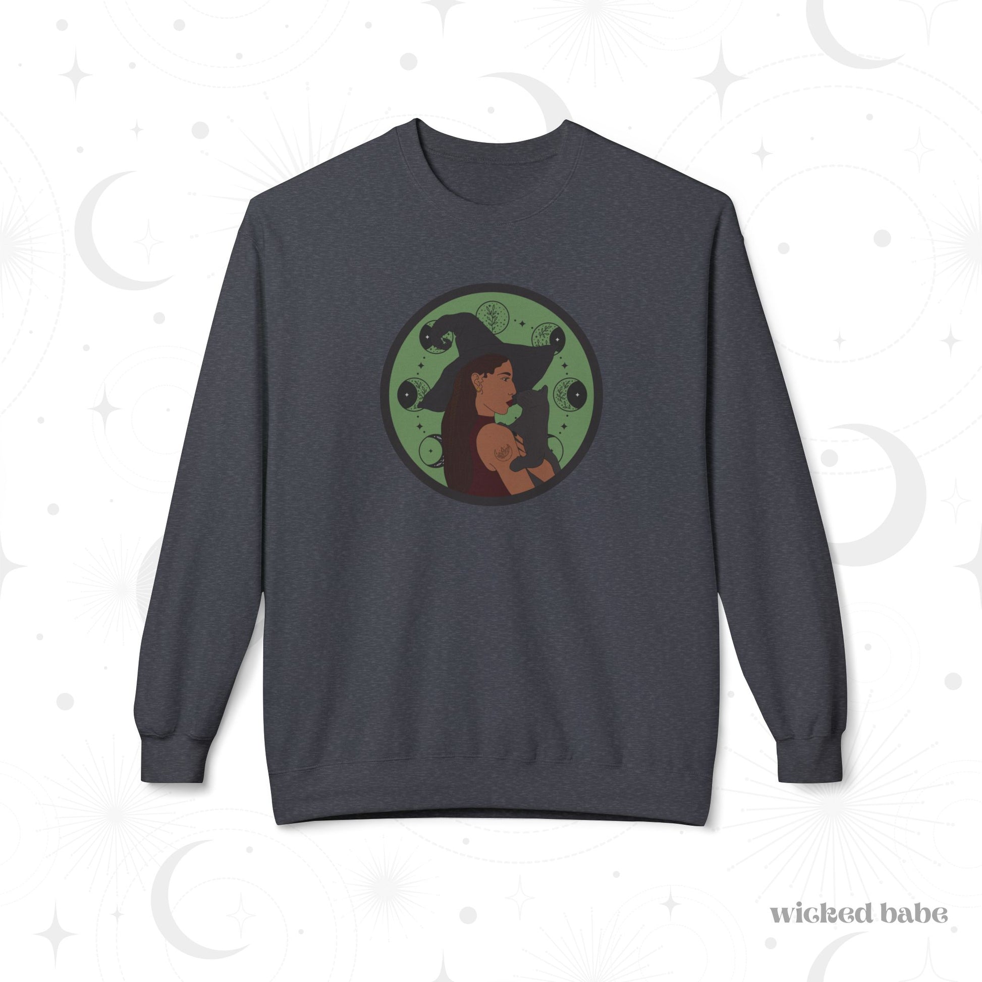 Dark heather gray crewneck long sleeve pullover sweatshirt featuring a design of a woman wearing a witch's hat holding a gray cat with moon phases on a green background