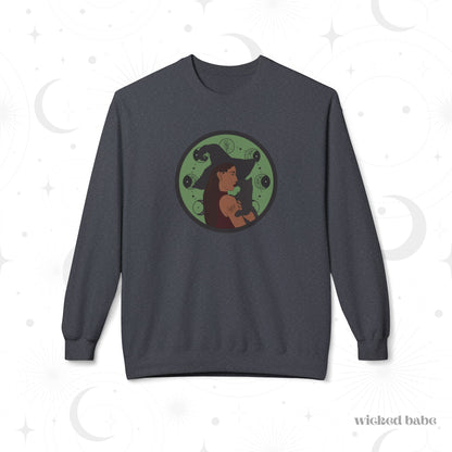 Dark heather gray crewneck long sleeve pullover sweatshirt featuring a design of a woman wearing a witch's hat holding a gray cat with moon phases on a green background