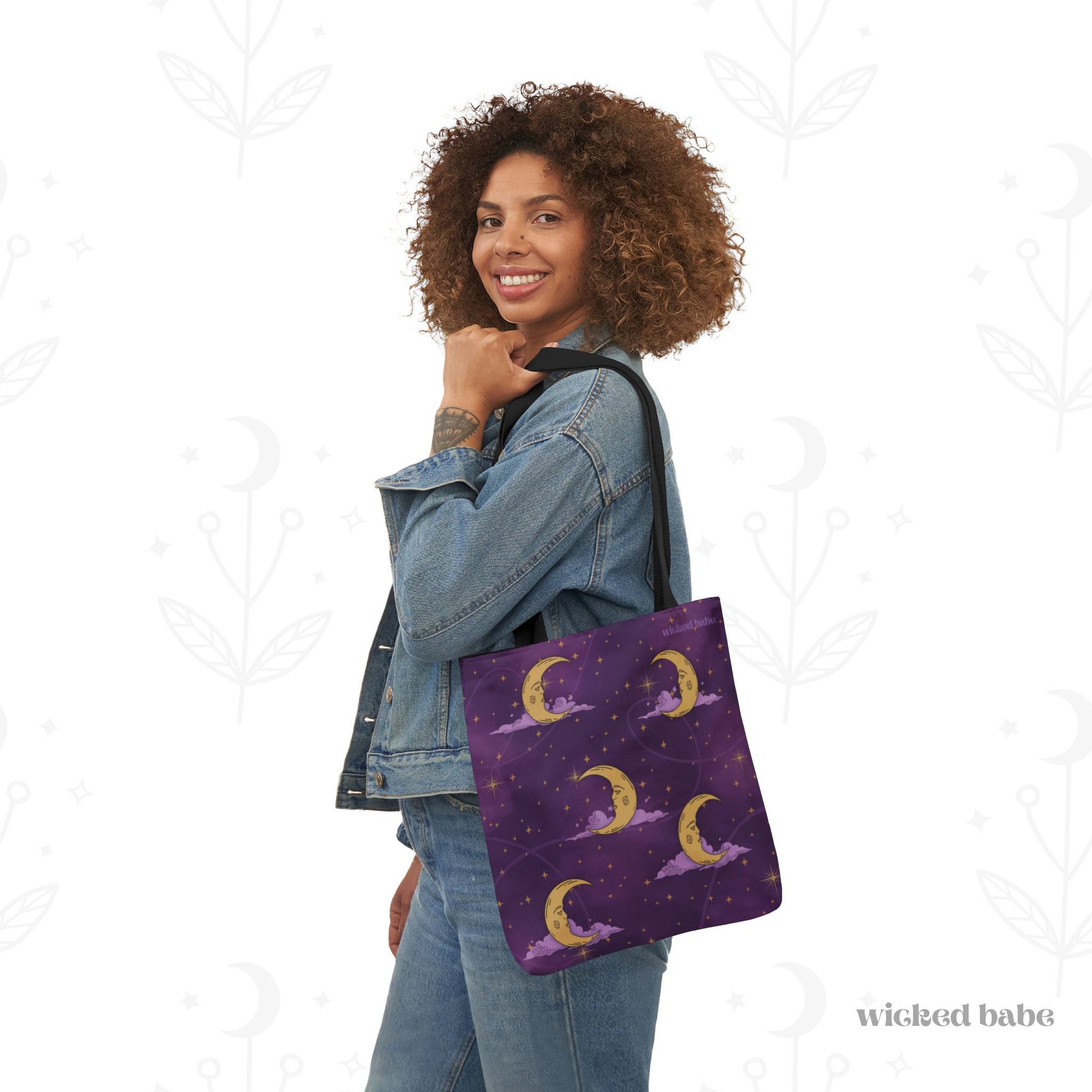 Woman carrying a 13x13 inch tote bag with purple celestial sky with gold crescent moon and stars