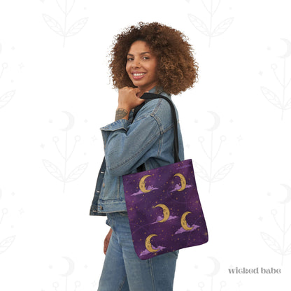 Woman carrying a 13x13 inch tote bag with purple celestial sky with gold crescent moon and stars
