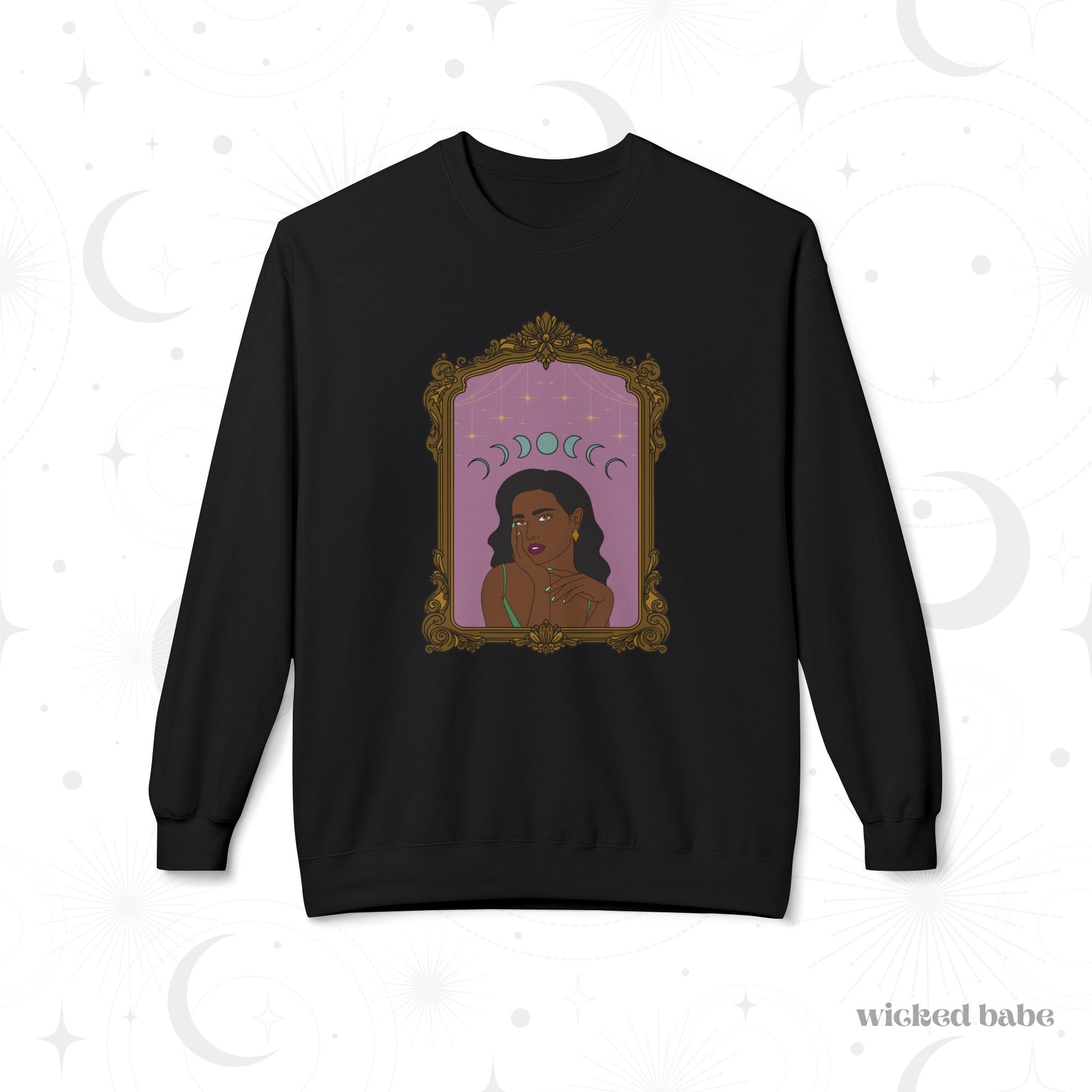 Black long sleeve crewneck sweatshirt with design of a dark skinned woman with black hair wearing green on a pink background with moon phases above surrounded by ornate gold frame